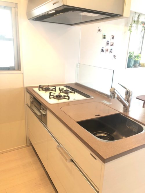 3口コンロ付きカウンターキッチン。キッチン裏には食器棚とパントリーあり